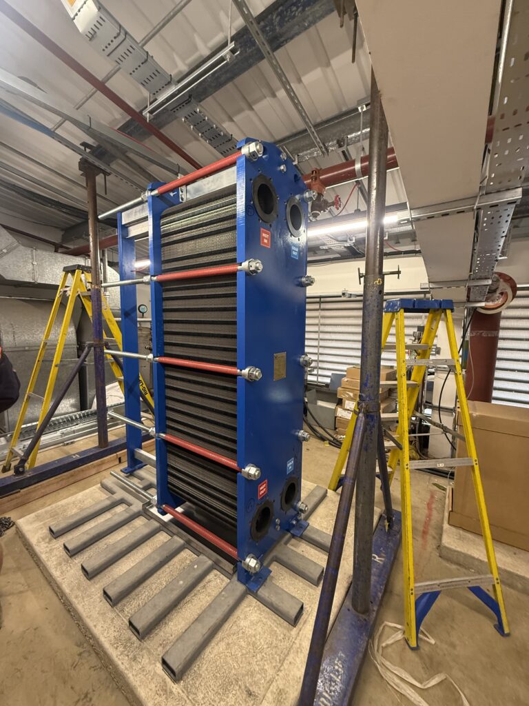 Heat exchanger supported by a gantry in a restricted plant room